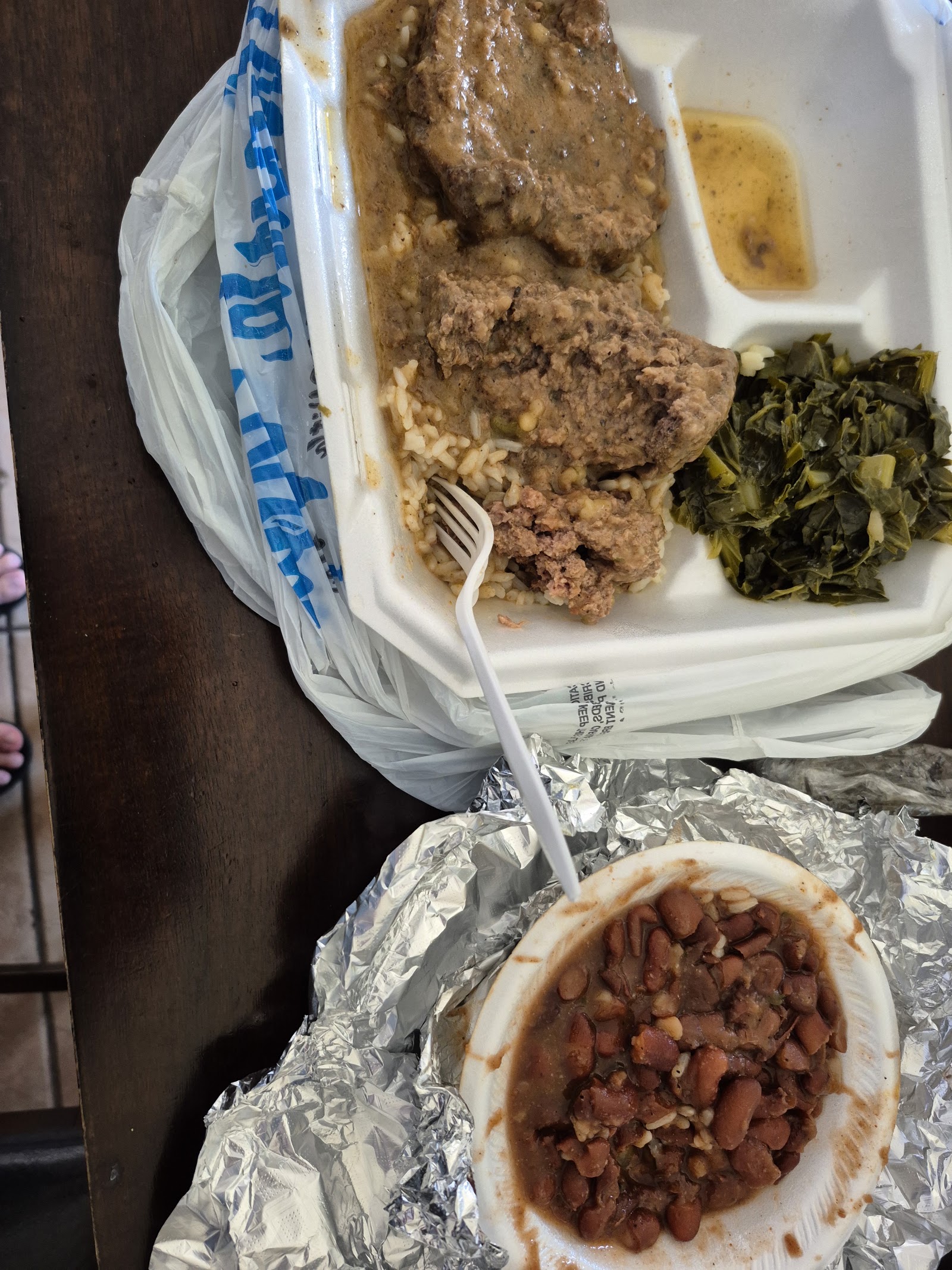 Smothered meatloaf plate with rice, gravy and collard greens